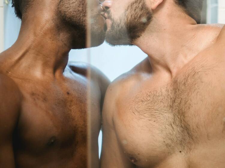 Two men kissing in a sauna