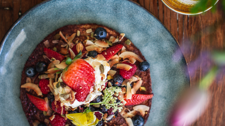 Flat lay of smoothie bowl and a latte