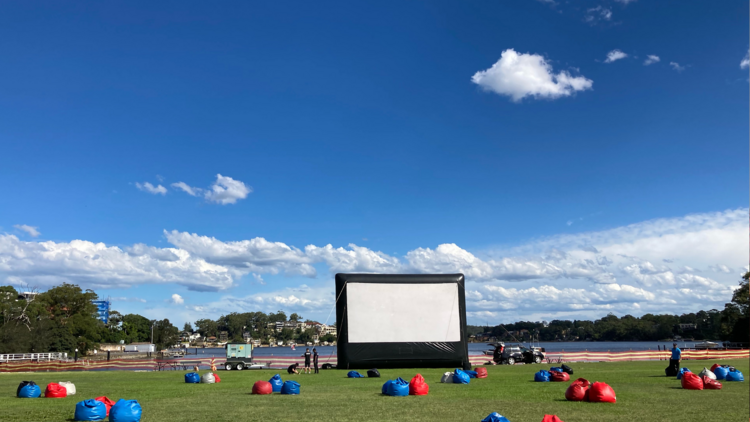 An outdoor cinema with a bunch of bean bags
