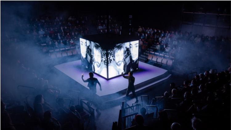 A theatre in the round has a cube screen on the square stage