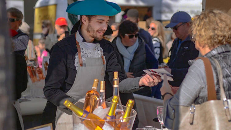 A bartender serving a woman at a festival bar