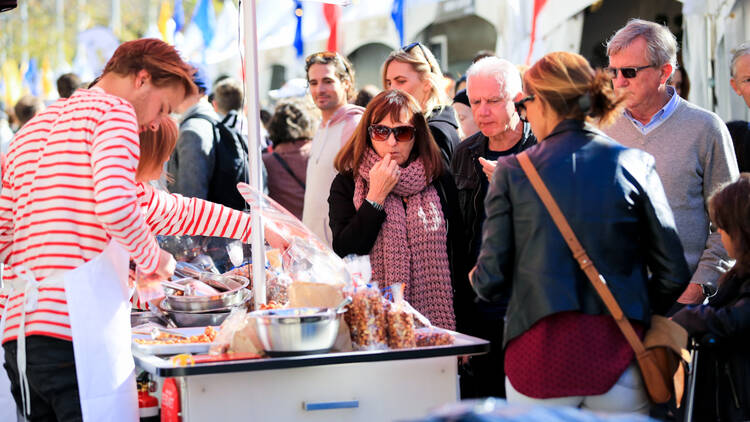 People gathering around a festival food stall