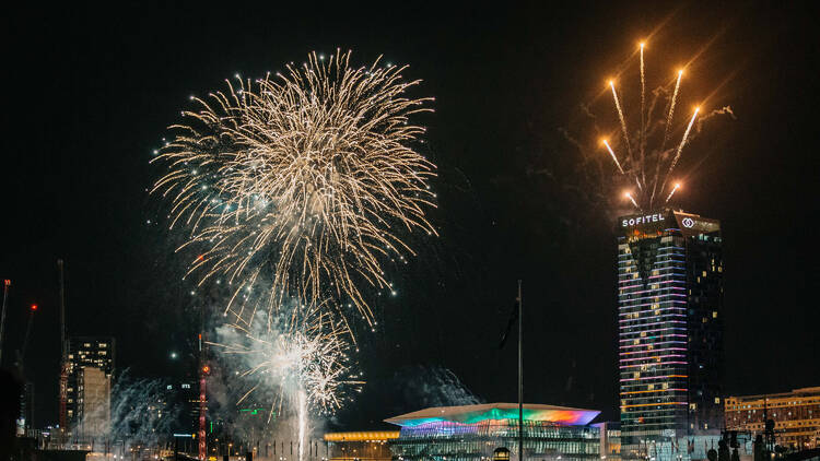 A photograph of fireworks and buildings