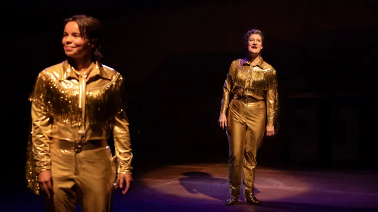Zoe Terakes and Virginia Gay in The Boomkak Panto in gold western outfits.
