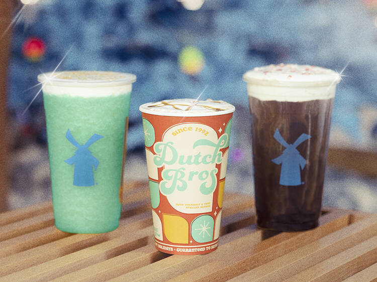 A photo of three drinks on a wooden table