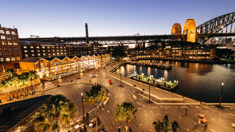 Lit up view at sunset of Sydney Harbour and the Harbour Bridge 