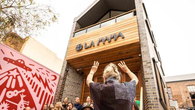 A smoking ceremony being carried out outside of La Mama following its rebuild