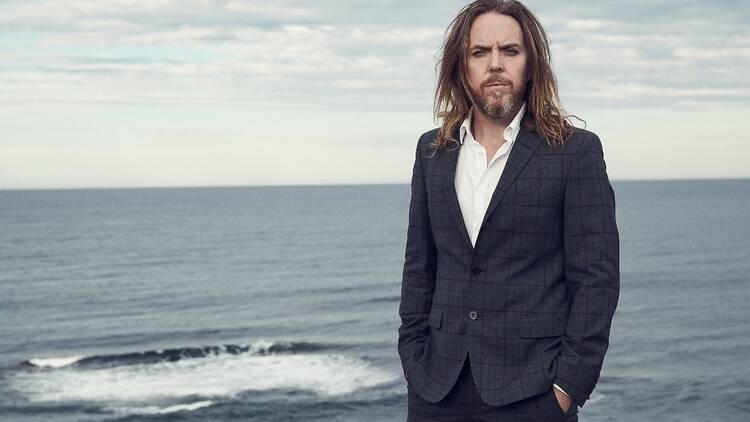 Tim Minchin with the ocean in the background