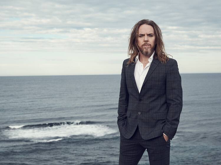 Tim Minchin with the ocean in the background