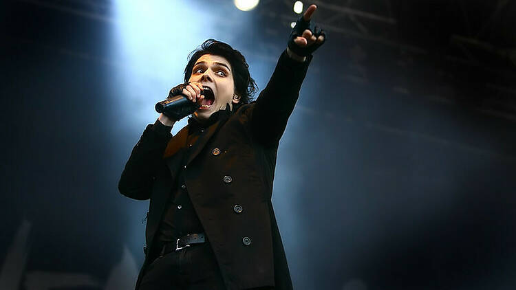 Gerard Way, the lead singer of My Chemical Romance, singing into a microphone. 