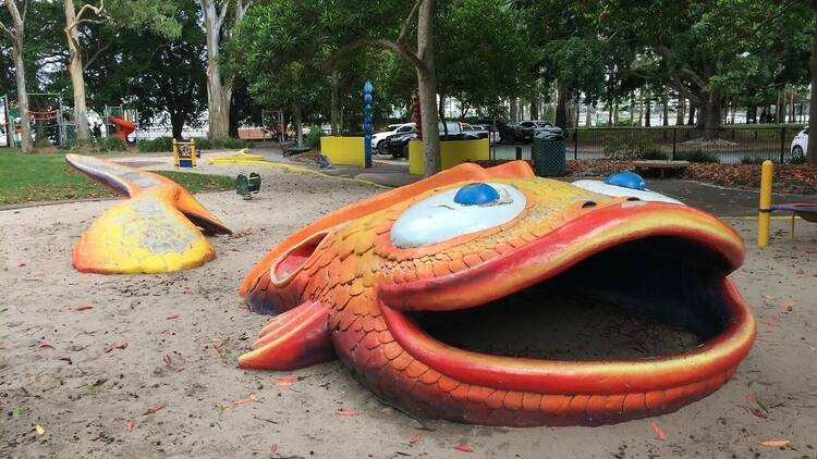 A giant fish in a playground for kids to climb on