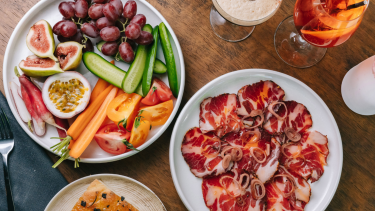 A flat lay of crudite, cured meat and cocktails