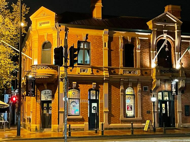 The outside of a historic Adelaide pub at night