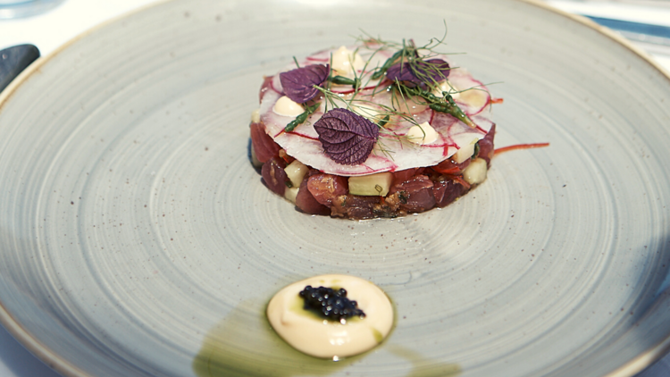 A plate of tuna carpaccio with emulsion and caviar