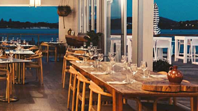 The interior of Thirty Three Degrees looking onto the water at dusk