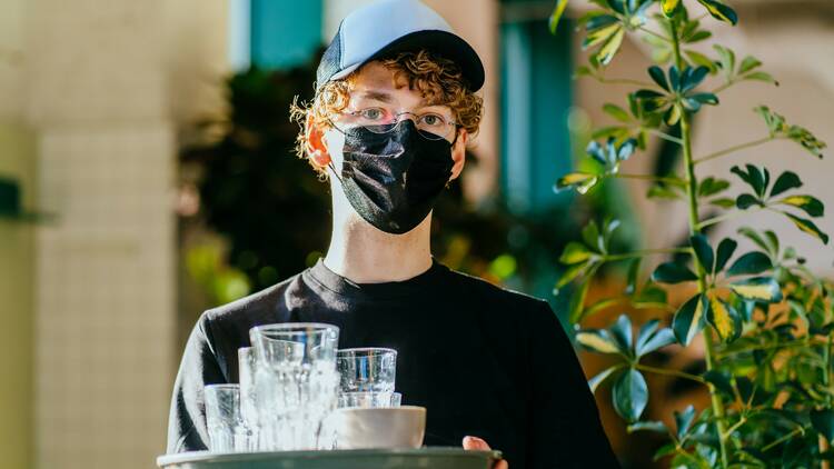 Masked waiter at a Sydney pub