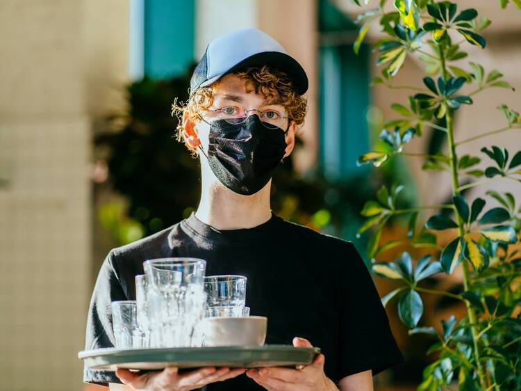 Masked waiter at a Sydney pub