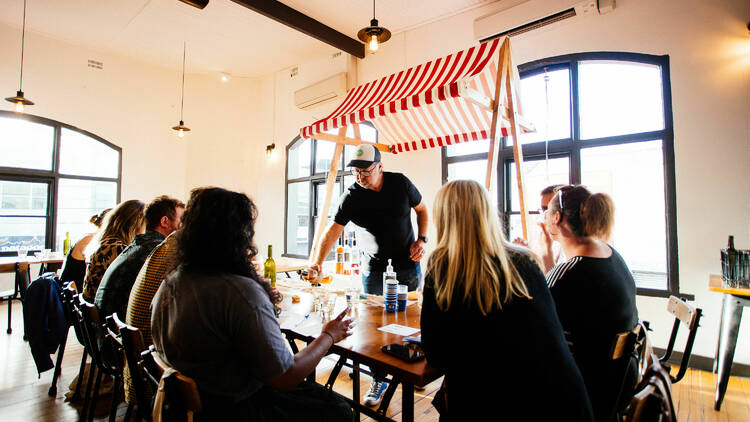 Craft & Co Summer Gin Market. A man serving up tastings of gin to a table.