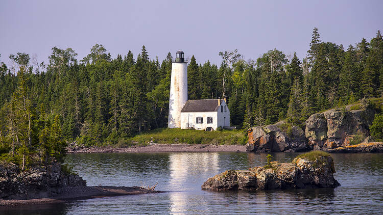 A photo looking over the water at Rock Harbor Lighthouse, in Isle Royale National Park, Michigan.