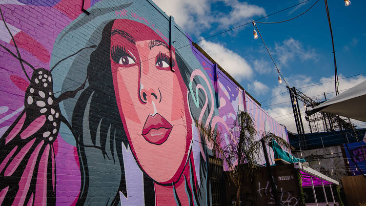 Pink mural of a woman at Pink Lemonade