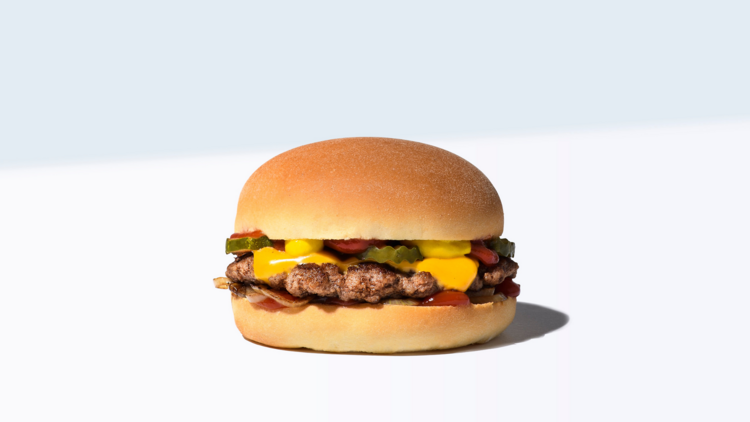 A double cheese burger on a blue and white background