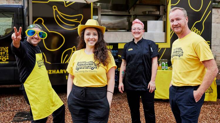 Four OzHarvest workers in front of their food truck