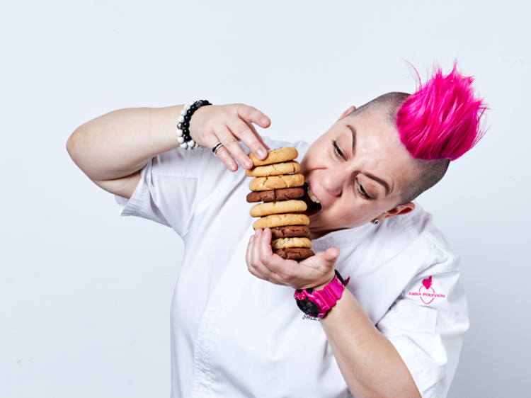 Anna Polyviou biting into a stack of cookies