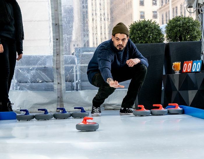 You can go ice curling on a rooftop in Times Square right now