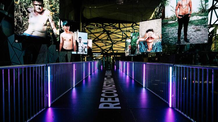 Lit up photographs on a raised platform in Fed Square