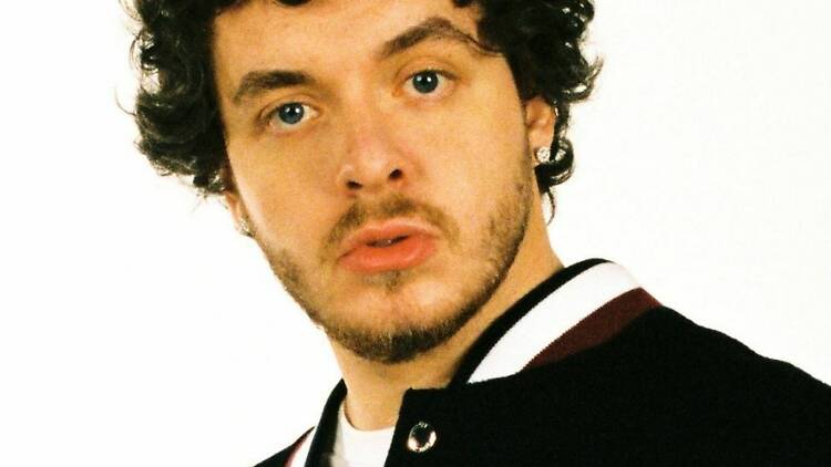 A close-up shot of singer Jack Harlow in a varsity jacket.