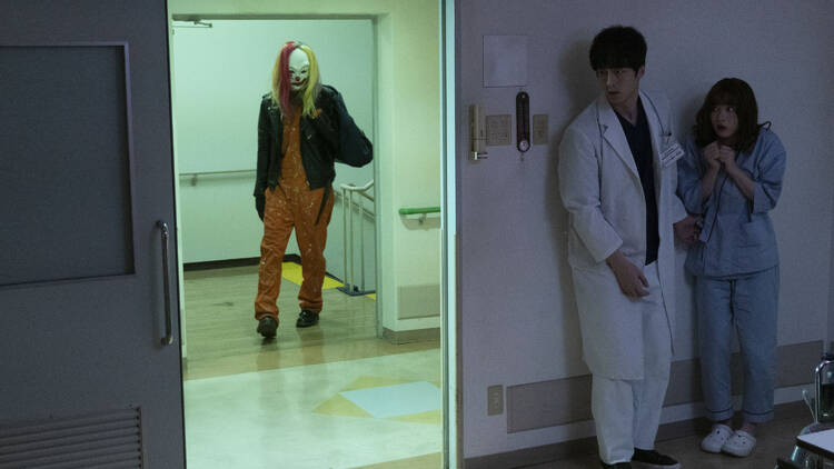 A scary clown prowling the corridors of a hospital