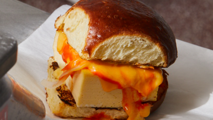 A bread roll with cheese and egg