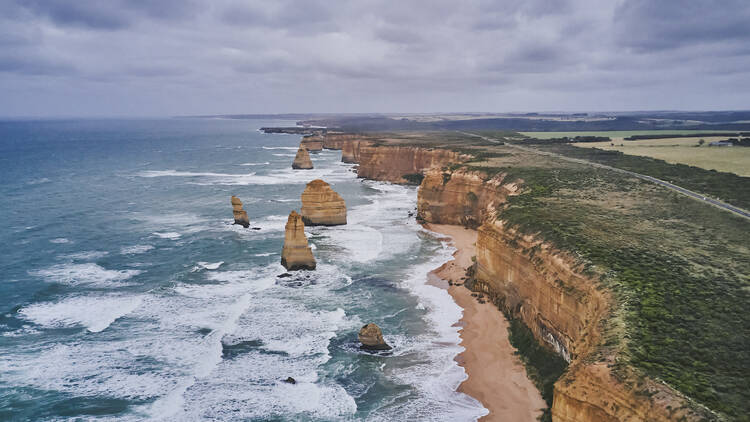 An aerial shot of the 12 Apostles and the Great Ocean Road.