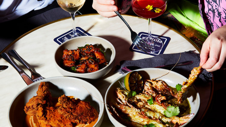 table with plates of Indian snacks