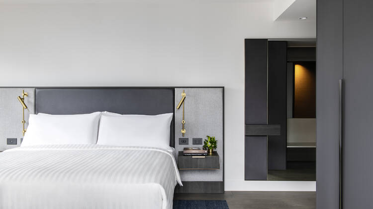 A premium room at the Melbourne Marriott Hotel Docklands with a king-sized bed.