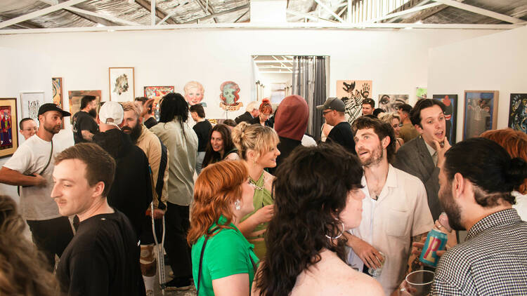 A group of people at Honey Bones Gallery for an exhibition. 
