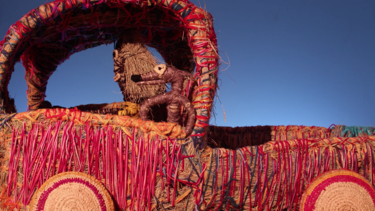 A truck made out of vibrant pink and orange thread