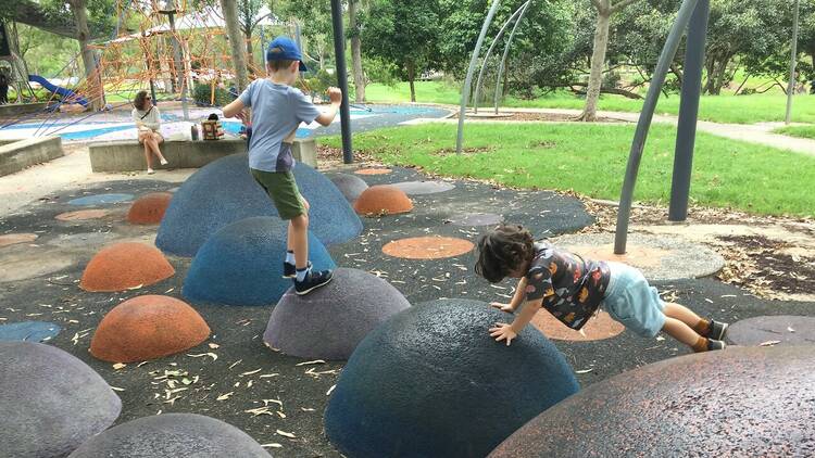 Kids playing on round soft boulders
