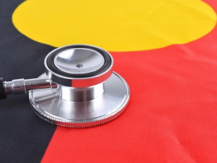 A stethoscope over an Aboriginal or Indigenous flag, with the colours black, gold and red.