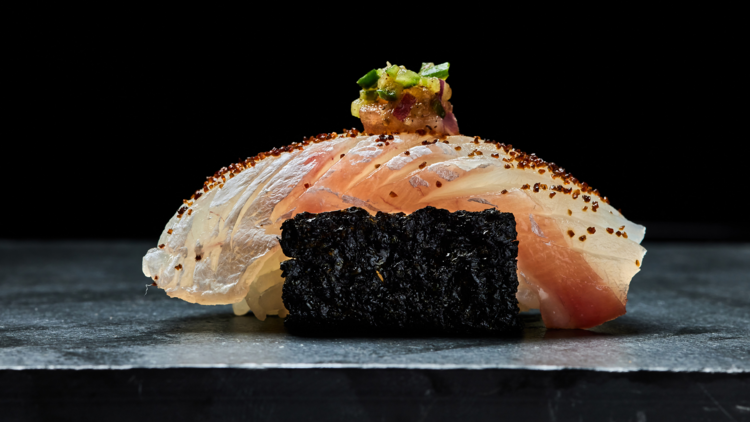 A piece of nigiri on a bed of seaweed