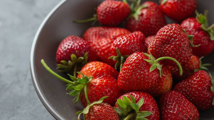 Fresh strawberries on a grey plate 