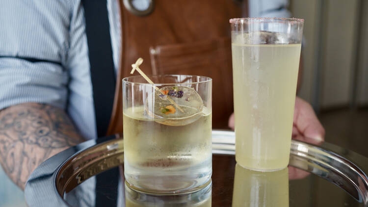 Two cocktails on a silver tray