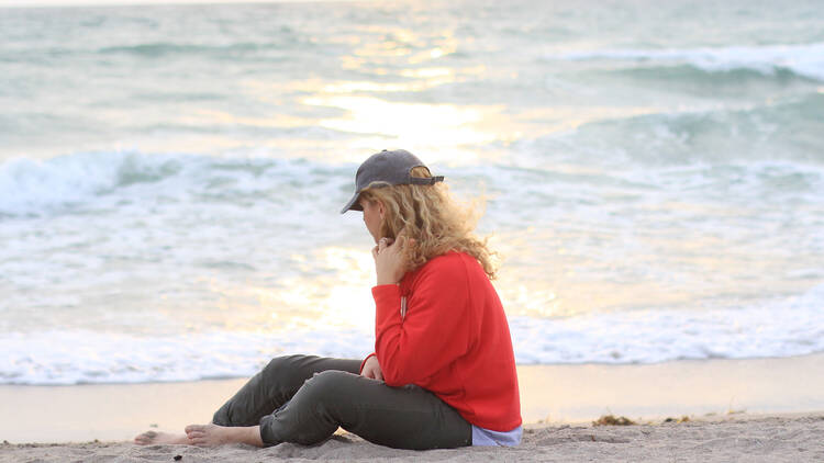 Woman on the beach crying