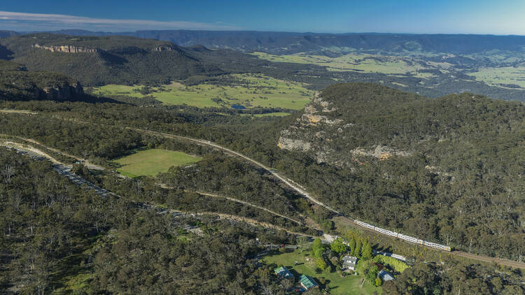 Train passing through Mount Victoria with scenic views of the World-Heritage listed Blue Mountains National Park.