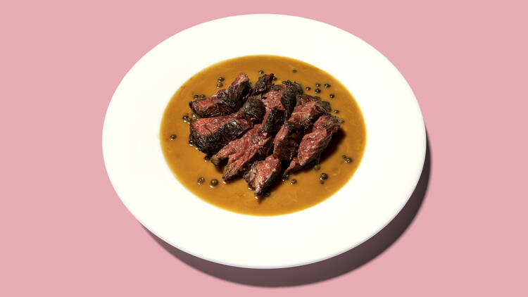 A photo of steak and peppercorn sauce