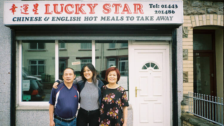 Angela Hui and parents outside their takeaway 