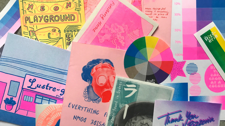 A collection of postcards and colourful paper cut outs