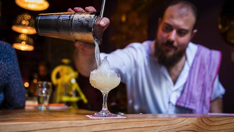 A bartender pouring a Margarita