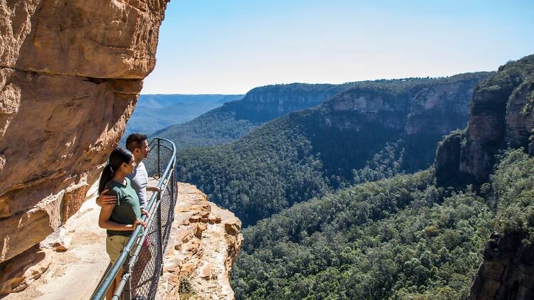 Couple enjoying a walk along the Wentworth Falls Track in the Blue Mountains National Park.