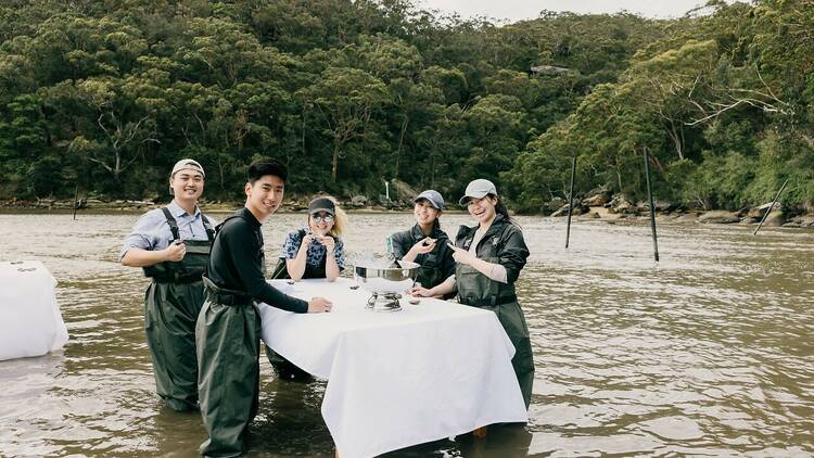 Shucking and eating oysters at an in-water table in the Hawkesbury